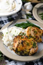 After you've browned the chicken thighs, transfer them to a baking pan and put them in the oven. Roasted Chicken Thighs With Garlic And Herbs The Seasoned Mom