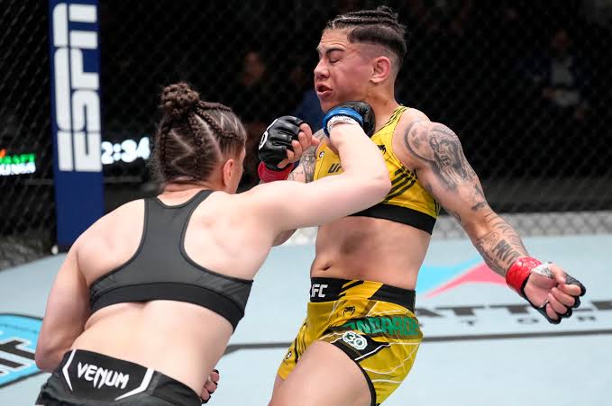 Erin Blanchfield applying a submission choke on the Octagon mat