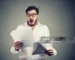 Image of shocked man looking at bank statements