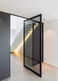 The pivot doors rotate on a pivot hinge that has a set of pins mounted on the top and bottom of the door. Floor Spring Aluminum Pivot Doors Wood Grain Transfer Surface Treatment Entrance Pivot Door Pivot Door Modern Exterior