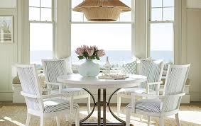 A coastal designer dining room nook by chango & co that stands out with a sleek design and glass float inspired lighting. Nantucket Furniture Kathy Kuo Home