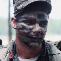 A Marine wearing camouflage face paint participates in Exercise SOLID  SHIELD '83,