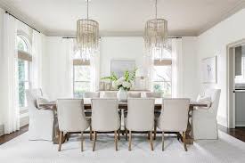Gray Glass Cascading Chandeliers Hung From A Gray Ceiling Illuminate A Wood Trestle Dining Table P Dining Room Layout Elegant Dining Room Christmas Dining Room