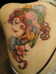 Black flower with eye tattoos on inner bicep. 25 Unbelievable Girl Back Tattoos Slodive
