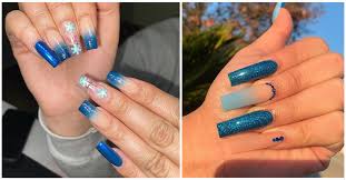 White nail polish is used as base to contrast the dark blue flower details. 50 Stunning Blue Nail Designs For A Bold And Beautiful Look In 2021