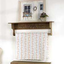 Drape a quilt or throw on the rod and place additional items on the shelf. Lakeside Wall Mounted Quilt Hanger And Shelf With Live Laugh Love Sentiment Target