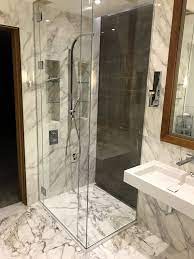 We cut, polish and temper glass shower doors and panels within 5 to 7 business days, assemble the hardware, and get everything ready for shipment or installation. Frameless Full Height Shower Enclosure Recessed Into Ceiling In Low Iron Glass With Finger Pull Handle Uv Bonded Mitred Corner In Battersea Reach Apartment