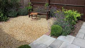 Grass sprouting from gravel on ground. Diy Pea Gravel Patio