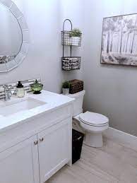 Powder Room Bathroom With White Cabinets Quartz Counter Top Round Bevelled Mirror And Farmhouse Acce Powder Room Decor White Bathroom Cabinets White Cabinets