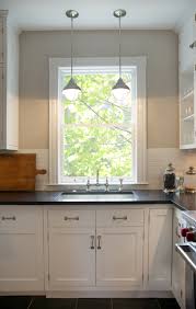 Everyone is searching for white kitchen cabinets with black countertops, according to pinterest. Pendants Over Kitchen Sink Contemporary Kitchen Scott Lyon Company