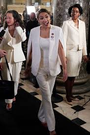 Alexandria Ocasio Cortez Commands Attention In A White Cape At The State Of Union Outfits White Outfits White Ruffle Blouse