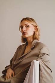 The sun setting through a dense forest.