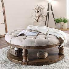 Round coffee tables offer an attractive contrast to the straight lines of most furniture. The Amstel Farmhouse Tufted Coffee Table Features A Stunning Weathered Finish With Sophisticated Coffee Table Farmhouse Round Ottoman Coffee Table Coffee Table