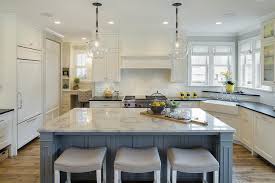 Kitchen with white cabinet and large island with three bar stools. Blue And Yellow Kitchen Design Cottage Kitchen