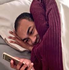 Wojak black guy looking sideways. Man Looking At Phone Smiling Laying In Bed With Blanket Meme Keep Meme