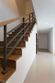 Cable railing will easily turn your space into a chic modern one, it will eliminate all the borders and won't prevent the spaces from a combination of metal and cable creates a railing that borders the staircase in this contemporary living space. Modern Wood And Iron Stairway Hand Railing Modern Stair Railing Stairs Design Modern Metal Stair Railing