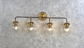 For a bathroom to be functional it needs to be vanity lighting is the perfect way to add bright task lighting that is necessary for daily bathroom minka aire fans, modern fan company, modern forms, modloft, modloft black, monte carlo fans. Everly Globe 4 Light Globe Vanity Sconce Black And Gold A Touch Of Design