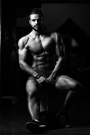 Good Looking And Attractive Young Man With Muscular Body Sitting On Bench And Relaxing In Gym Banco De Imagens Royalty Free Ilustracoes Imagens E Banco De Imagens Image 81237222