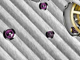 CÔTES DE GENÈVE A decoration of undulating lines, frequently used to  embellish superior quality movements. It has something of the look of waves  as they lap upon the shore, which is the