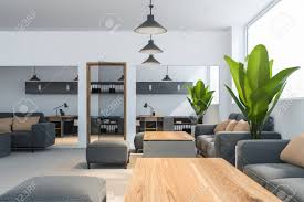 Costly to heat and cool. Interior Of Office Waiting Room With Gray Sofas Standing Near Wooden Tables Open Space Office With Glass Doors In Background 3d Rendering Lizenzfreie Fotos Bilder Und Stock Fotografie Image 121112222