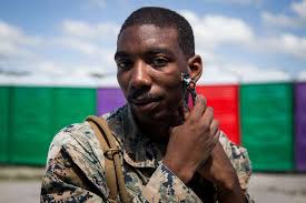 U.S. Marine Cpl. Micheal Johnson shaves during KAMANDAG