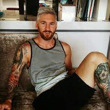 A hair colourist, a man using a paintbrush to cover sections of a womans blonde hair. Top Tips For Men Thinking Of Dying Their Hair Blonde Regal Gentleman