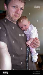 Man holding a baby which has been sick