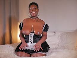 Naughty maid Asia Drake showing her big tits and shaved pussy photos