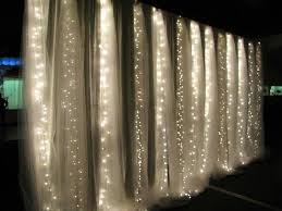 Wedding hall decor tulle and twinkle lights. Tulle Wall With Lights Behind It For A Starry Background Wedding Decorations Twinkle Lights Lights