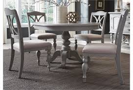 Another thing that makes a pedestal dining table so desirable in terms of aesthetics is the fact that they have a symmetrical shape which makes them very. Liberty Furniture Summer House Dining Transitional Round Pedestal Table With 12 Table Leaf Lindy S Furniture Company Kitchen Tables