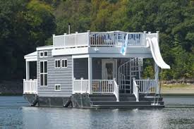 The helm station graces the front starboard corner. This Tiny Houseboat Lets You Float Your Cares Away For 9 000