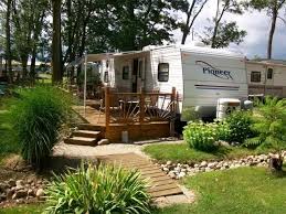 A rocking chair peeking out above the railing or a porch swing at one end of the porch can also enhance the space. Deck Ideas For A Camper Our Camper Project Four Generations One Roof
