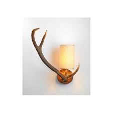 This lamp has a burnished bone ivory finish with a crackled wood tone base and cast aluminum accents. Antler Stag Wall Light With Cream Shade Left Facing