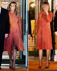Bundled up in a a shiny theodore scanlan trench coat made of patent leather. Melania Trump And Donald Trump Ditch Face Masks For Halloween Event At White House Express Co Uk