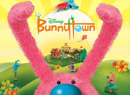 On a tangerine background, an oval with a stylized fox wearing an artist's cap, inside a circle with spiffy at the top and pictures at the bottom, zooms out to the middle of the screen. Bunnytown Tv Show Air Dates Track Episodes Next Episode
