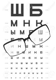 glasses on the table with eye test chart in the background for