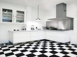 Covering the walls are black marble tile set in a herringbone pattern. Great Idea 30 Most Popular Kitchen Design With Black White Flooring Ideas Https Usdecora Popular Kitchen Designs White Kitchen Tiles Black And White Flooring