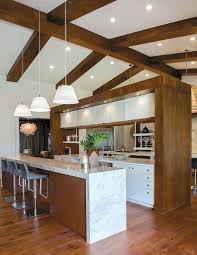 Full overlay walnut custom kitchen cabinets with austere doors emphasize simplicity, helping to keep the focus on the design of the space. Clarifying Contemporary Kitchen Bath Design News
