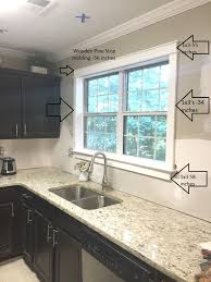 My preferred way to do what your asking is tile the backsplash so the lip of the tile sits 1/2 to an inch under the trim. Diy Craftsman Trim Live Pretty On A Penny