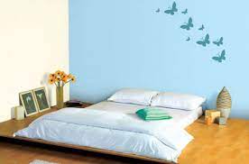 A bright white ceiling and crown molding ensure that the room still makes good use of natural light. Blue Bedroom Feature Wall In Soft Blue 9210 With Neutral On Other Walls Butterfly Stencil With Prair Blue Bedroom Dark Blue Bedrooms Living Room Paint Design