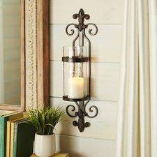 It has a texture that would bring a vintage feel to the home. Iron Fleur De Lis Pillar Candle Holder Wall Sconce Candle Holder Wall Sconce Wall Candle Holders Candle Sconces Living Room