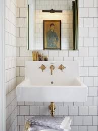 white bathrooms with brass fixture