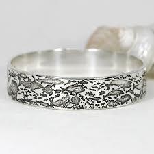 The bangle bracelet features contrasting spots inspired by the mexican jaguar, or tigrillo. Silver Bangles John Miller Design
