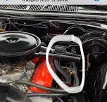 What is the small black hose in the engine?