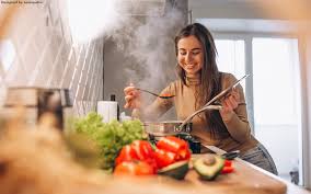 Pretty young woman in casualwear standing by stove and tasting food while cooking soup in pan. 12 Gute Online Shoppingtipps Fur Die Zeit Zu Hause Teil 2