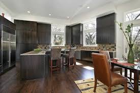 Dark wood floors in a kitchen provide a strong base for the room. 46 Kitchens With Dark Cabinets Black Kitchen Pictures