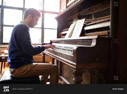 Check spelling or type a new query. Young Man Playing An Upright Piano Stock Photo Offset