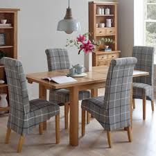Eames style soft padded seat dining chairs with solid wooden legs. Vancouver Compact Oak Extending Dining Table 4 Grey Tartan Chairs