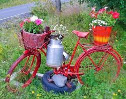 2 bicycles bright pink and purple in a large garden holding flowers. Turn Your Old Bike Into An Original Garden Decoration 1001 Gardens