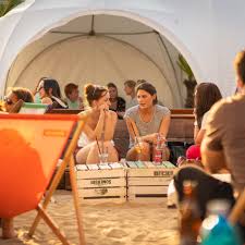 Soak up the rays, grand city views and colourful cocktails at this beach bar in the sky while sinking your toes into tonnes of sand lugged to the top parking deck of the schönhauser arkaden mall. Strandbar Deck5 Berlins Hochste Strandbar